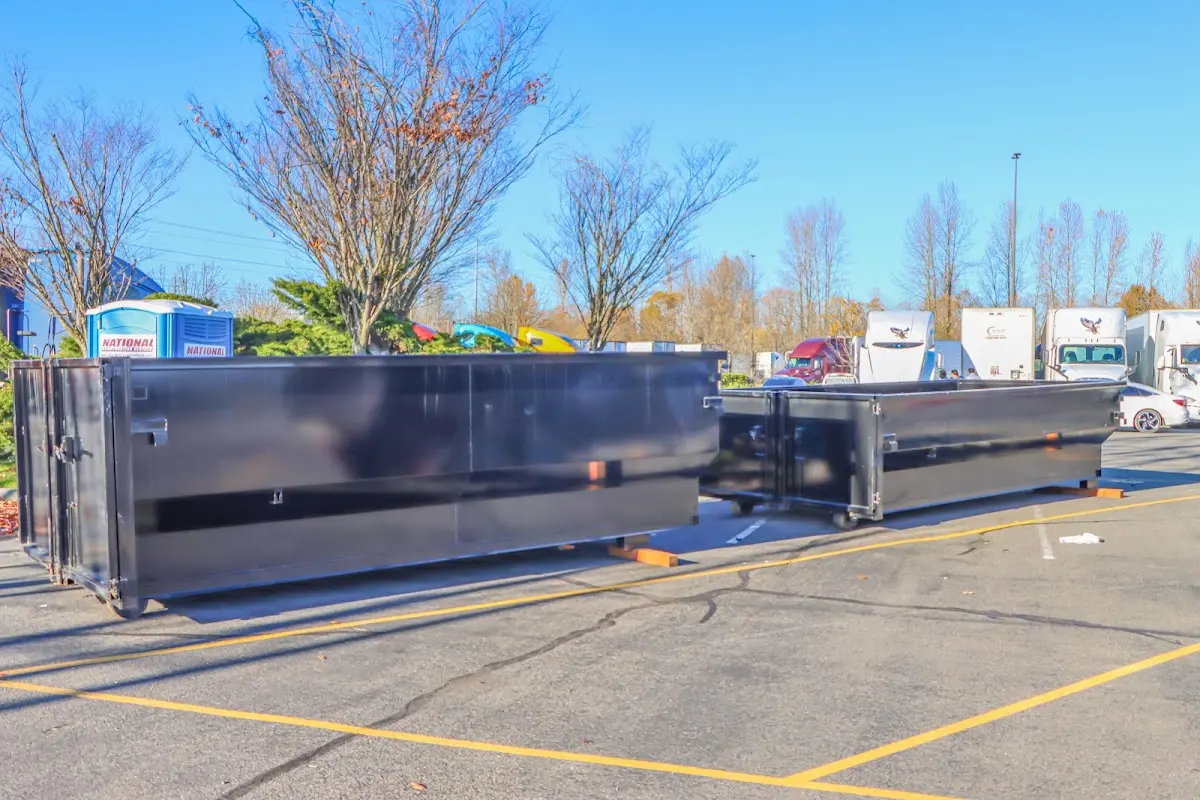 Professional dumpster rental service with roll-off container on residential driveway in Malverne